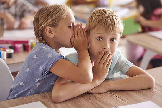 Girl telling friend a big secret